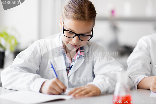 Image of girl studying chemistry at school laboratory