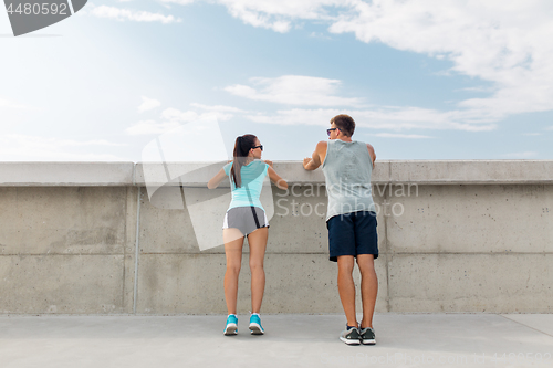 Image of happy couple exercising outdoors