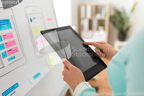 Image of close up of ui designer with tablet pc at office
