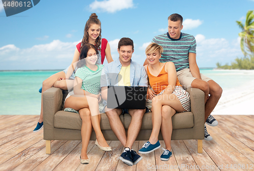 Image of friends with laptop over tropical beach