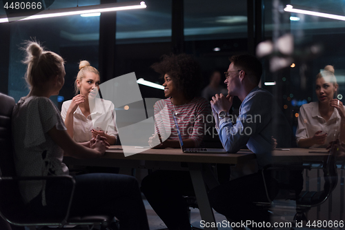 Image of Multiethnic startup business team in night office