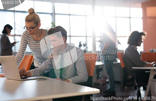 Image of Two Business People Working With laptop in office