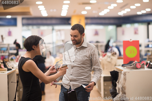 Image of couple chooses shoes At Shoe Store