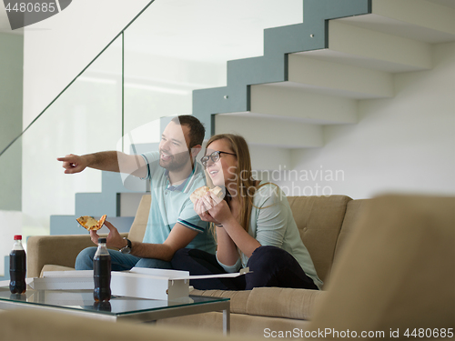 Image of couple eating pizza in their luxury home villa