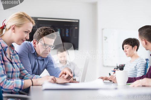 Image of Two Business People Working With laptop in office