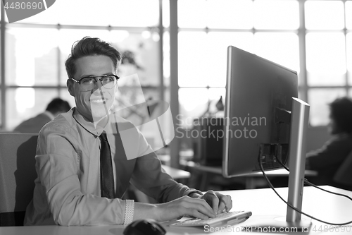 Image of businessman working using a computer in startup office