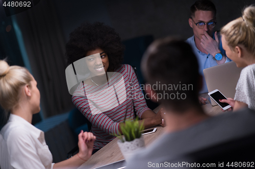 Image of Multiethnic startup business team in night office