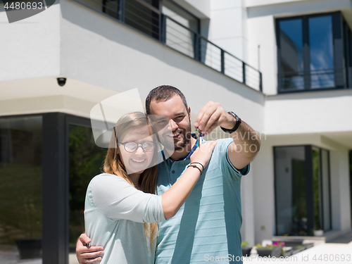 Image of couple hugging in front of  new luxury home