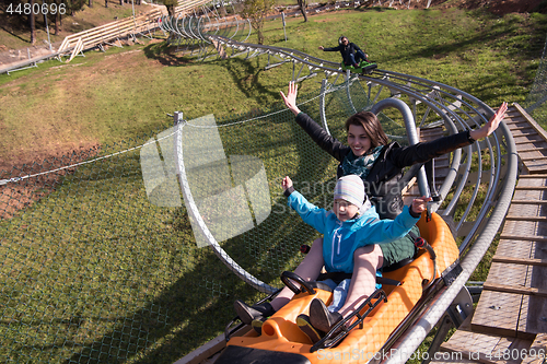Image of mother and son enjoys driving on alpine coaster