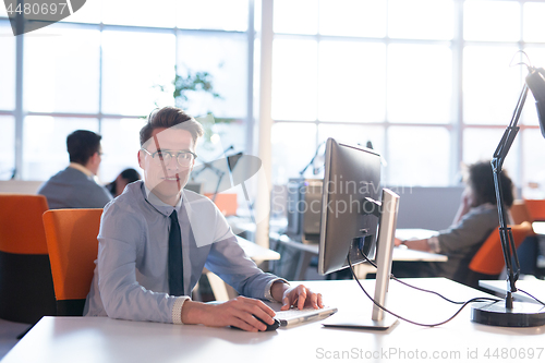 Image of businessman working using a computer in startup office