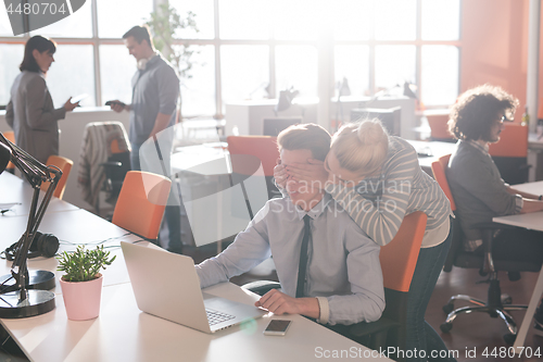 Image of Two Business People Working With laptop in office