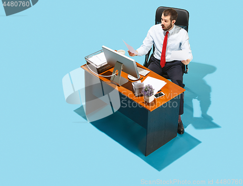 Image of Shot from above of a stylish business man working on a laptop.