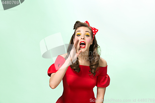 Image of Beautiful young woman with pinup make-up and hairstyle. Studio shot on white background