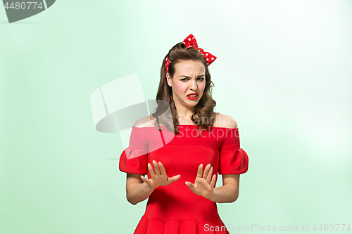 Image of Beautiful young woman with pinup make-up and hairstyle. Studio shot on white background