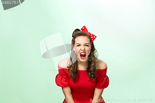 Image of Beautiful young woman with pinup make-up and hairstyle. Studio shot on white background