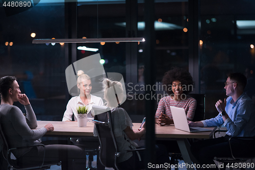 Image of Multiethnic startup business team in night office