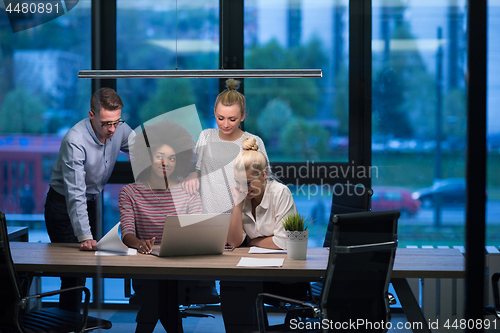 Image of Multiethnic startup business team in night office