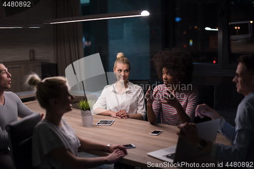 Image of Multiethnic startup business team in night office