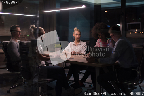 Image of Multiethnic startup business team in night office