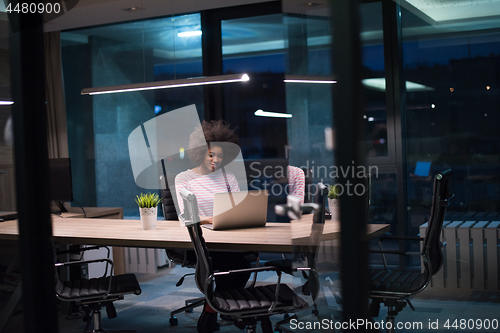 Image of black businesswoman using a laptop in startup office