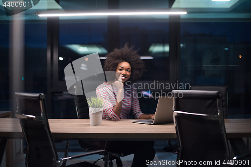 Image of black businesswoman using a laptop in startup office