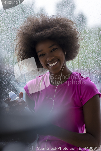 Image of portrait of young afro american woman in gym