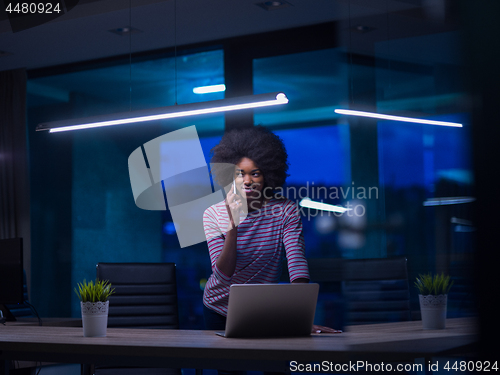 Image of black businesswoman using a laptop in startup office