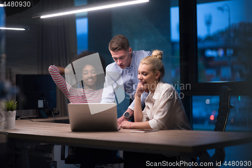 Image of Multiethnic startup business team in night office