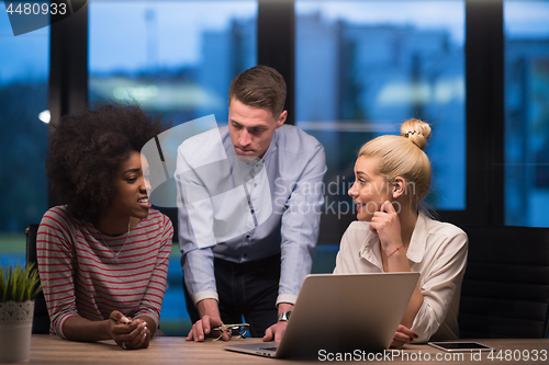 Image of Multiethnic startup business team in night office