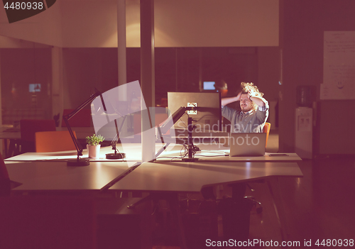 Image of businessman relaxing at the desk