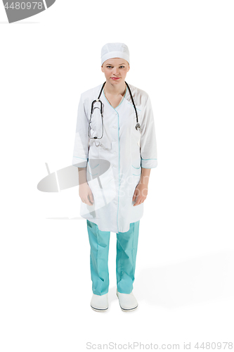 Image of Beautiful young woman in white coat posing and smiling at studio. Full length studio shot isolated on white.