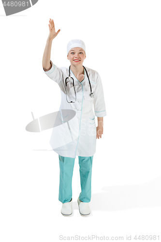 Image of Beautiful young woman in white coat posing at studio. Full length studio shot isolated on white.