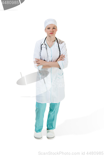 Image of Beautiful young woman is standing seriously in white coat posing at studio. Full length studio shot isolated on white.
