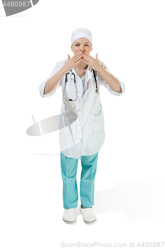 Image of Beautiful young woman is sending an air kiss in white coat posing at studio. Full length studio shot isolated on white.