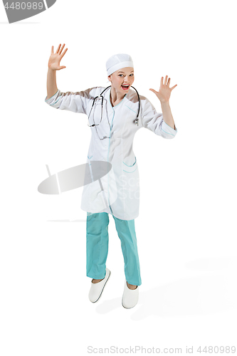 Image of Beautiful young woman in white coat posing at studio. Full length studio shot isolated on white.