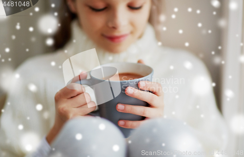 Image of close up of girl in winter sweater with cacao mug