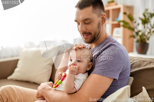 Image of happy father with little baby daughter at home