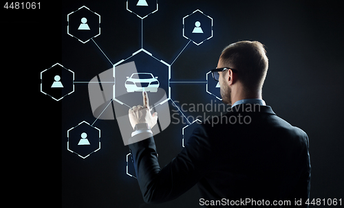 Image of businessman with virtual hologram of car sharing