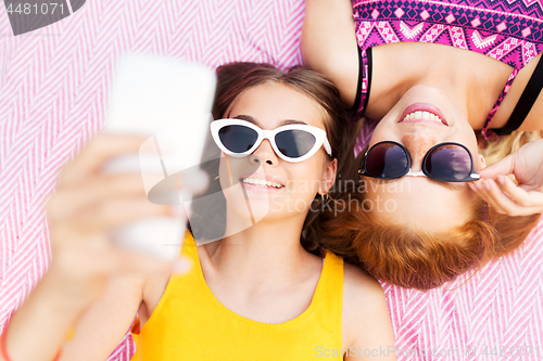 Image of teenage girls in sunglasses taking selfie