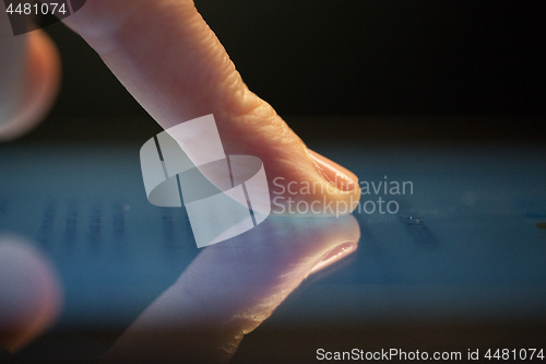 Image of close up of hand using computer touch screen