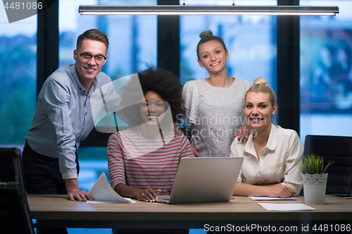 Image of Multiethnic startup business team in night office