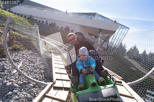 Image of father and son enjoys driving on alpine coaster