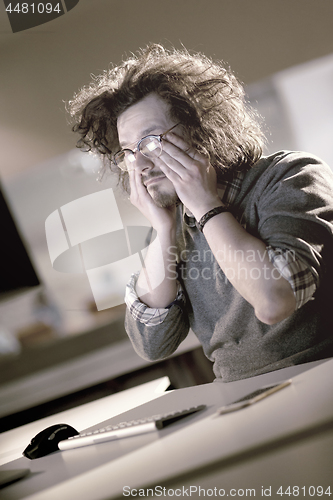 Image of businessman relaxing at the desk