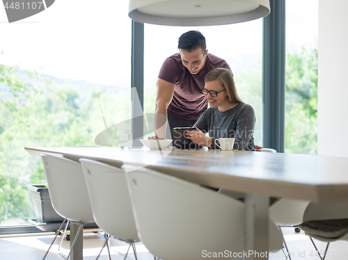 Image of couple enjoying morning coffee and strawberries