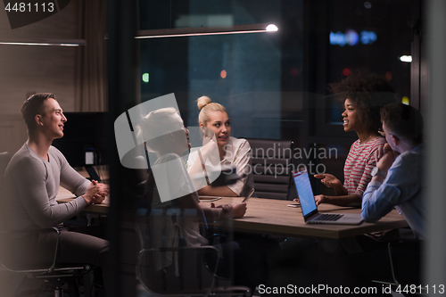 Image of Multiethnic startup business team in night office