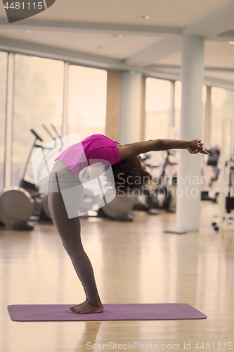 Image of african american woman exercise yoga in gym