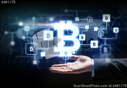 Image of buisnessman hand with bitcoin block chain