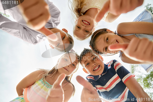 Image of happy children showing thumbs up in circle