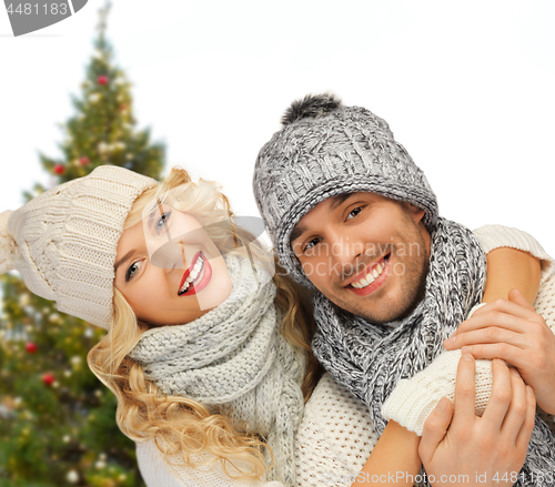 Image of happy couple hugging over christmas tree