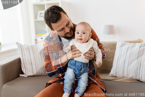 Image of happy father with little baby boy at home